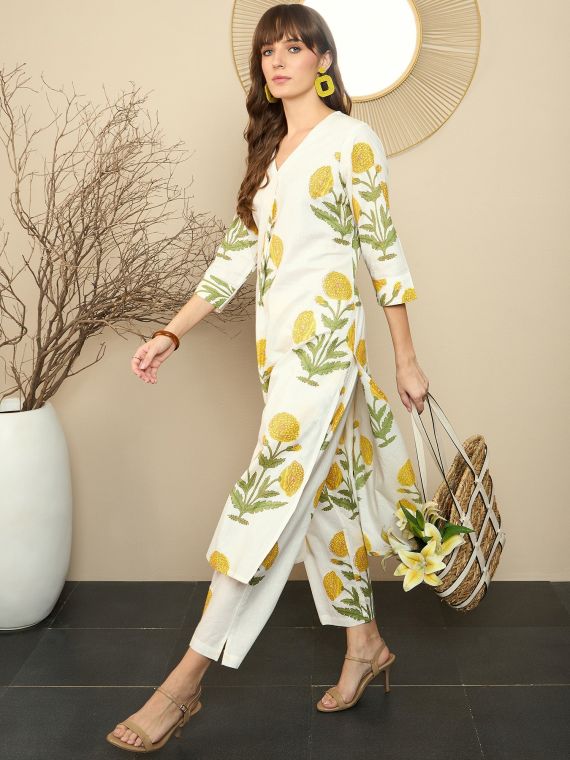 white cotton kurta and pants set with yellow floral print.